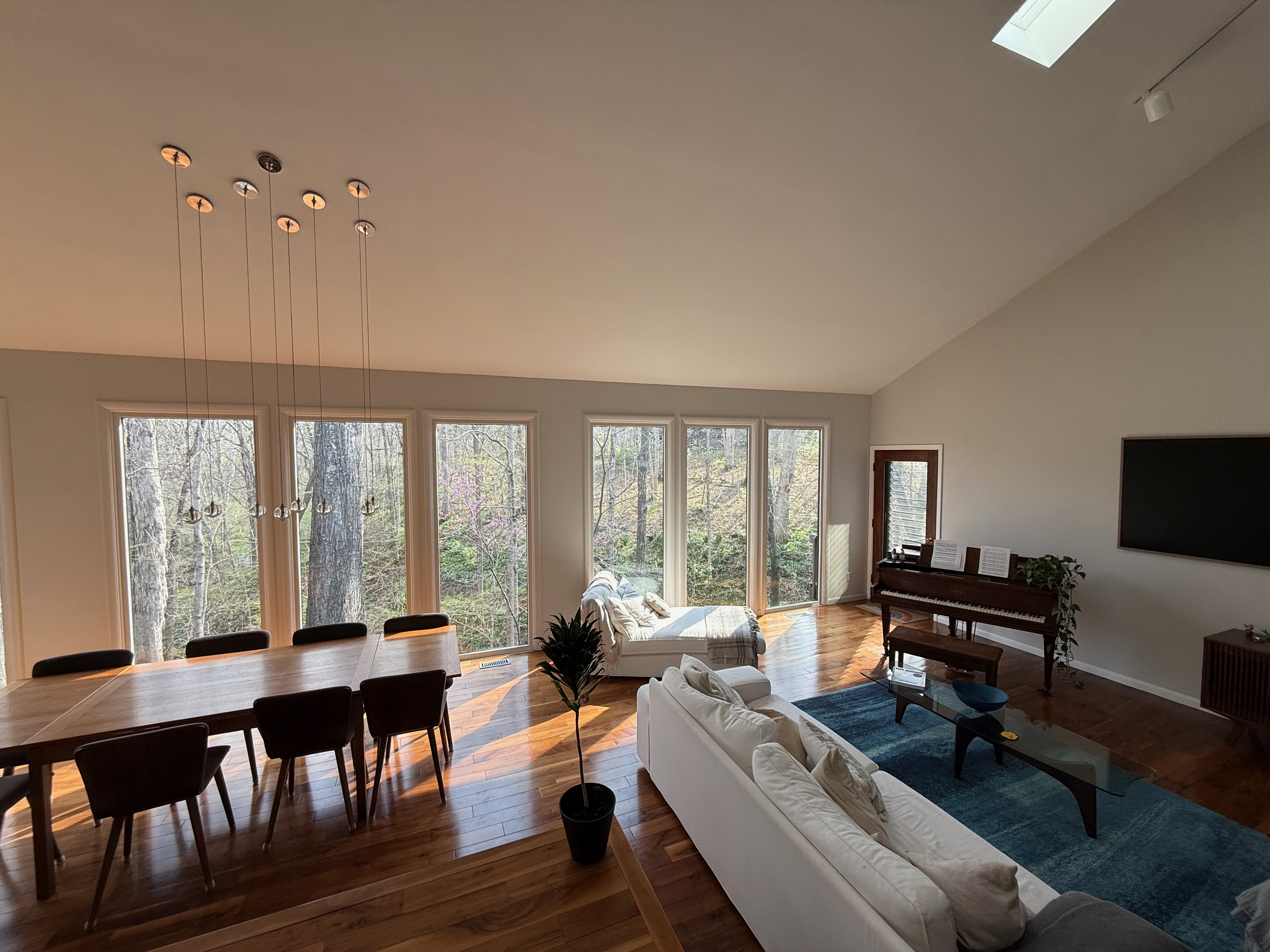 Great room with floor-to-ceiling forest windows